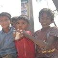 Rohingya_Refugees_Camp_in_2019,UkhiaBangladesh, Looks like: 4 boys, one piece of bread - one boy smiling (?)
